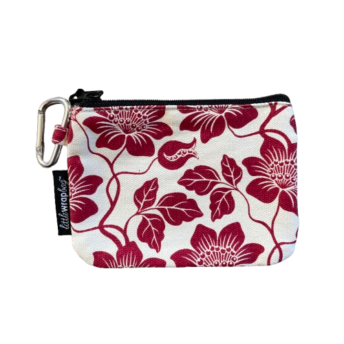 Simple purse in cream fabric with red floral pattern and a carabiner clip.