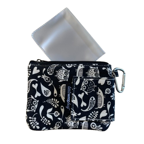 Black purse with white floral and owl print with a plastic card sleeve that tucks inside the purse.