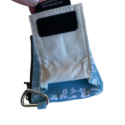Blue coloured purse with white print showing the velcro closing back pouch feature.