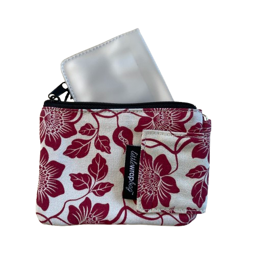 Cream coloured purse with red floral print with a plastic card sleeve that tucks inside the purse.