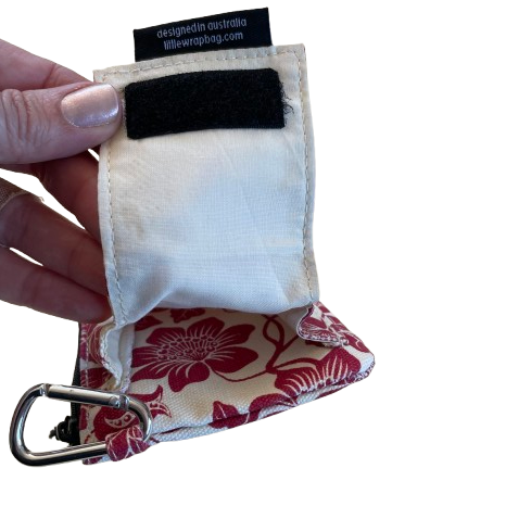 Cream coloured purse with red floral print showing the velcro close pouch on the reverse side.