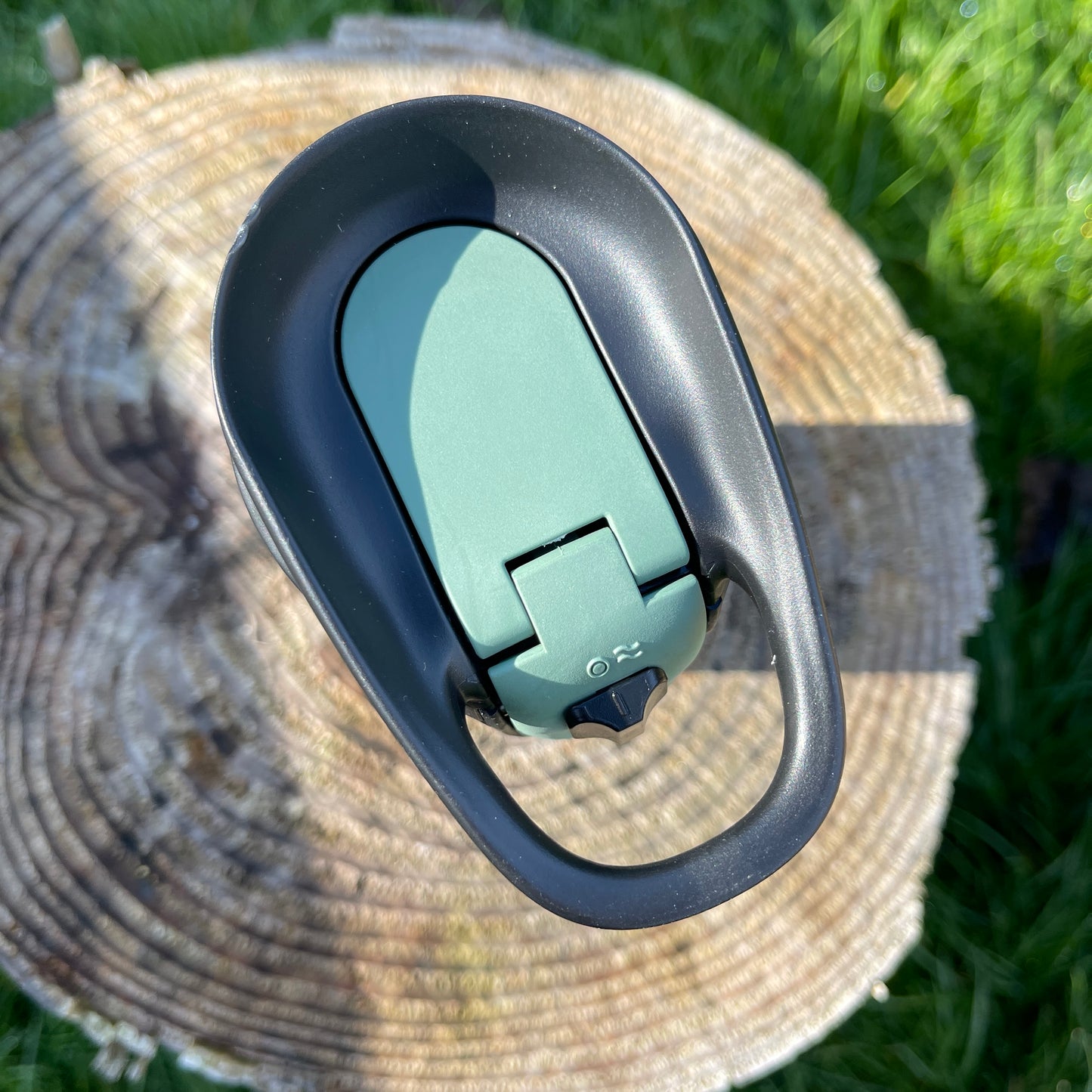 Stainless steel Camelbak insulated coffee cup with a press to sip function in moss green colour.