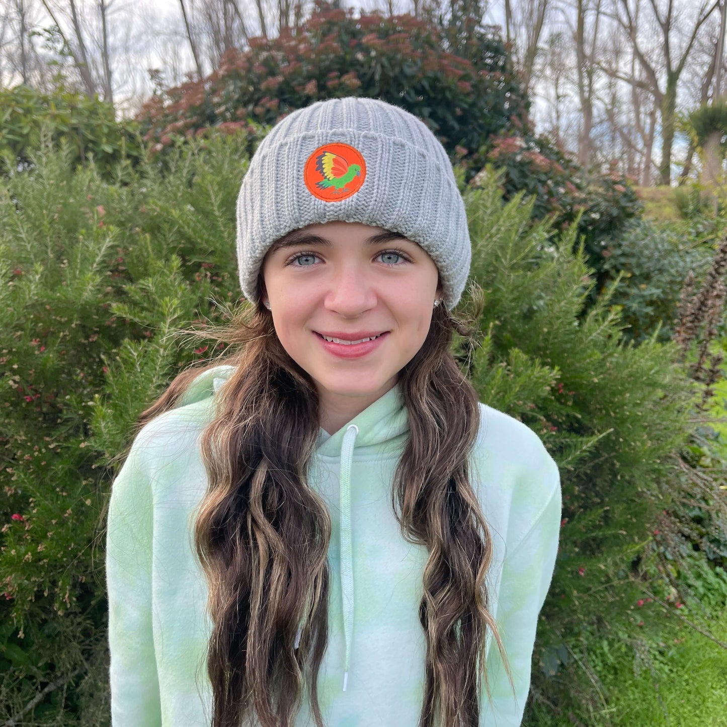 Kids grey knit beanie with Kea bird emblem.
