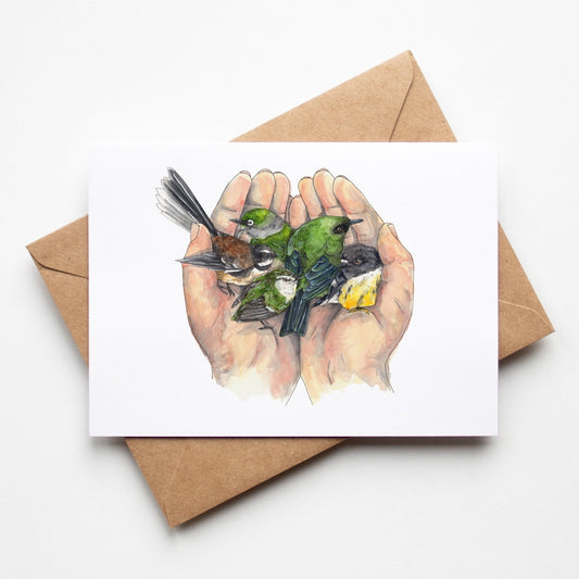Greeting card by Leah Ingram Artist featuring 2 hands holding 5 small New Zealand native birds.