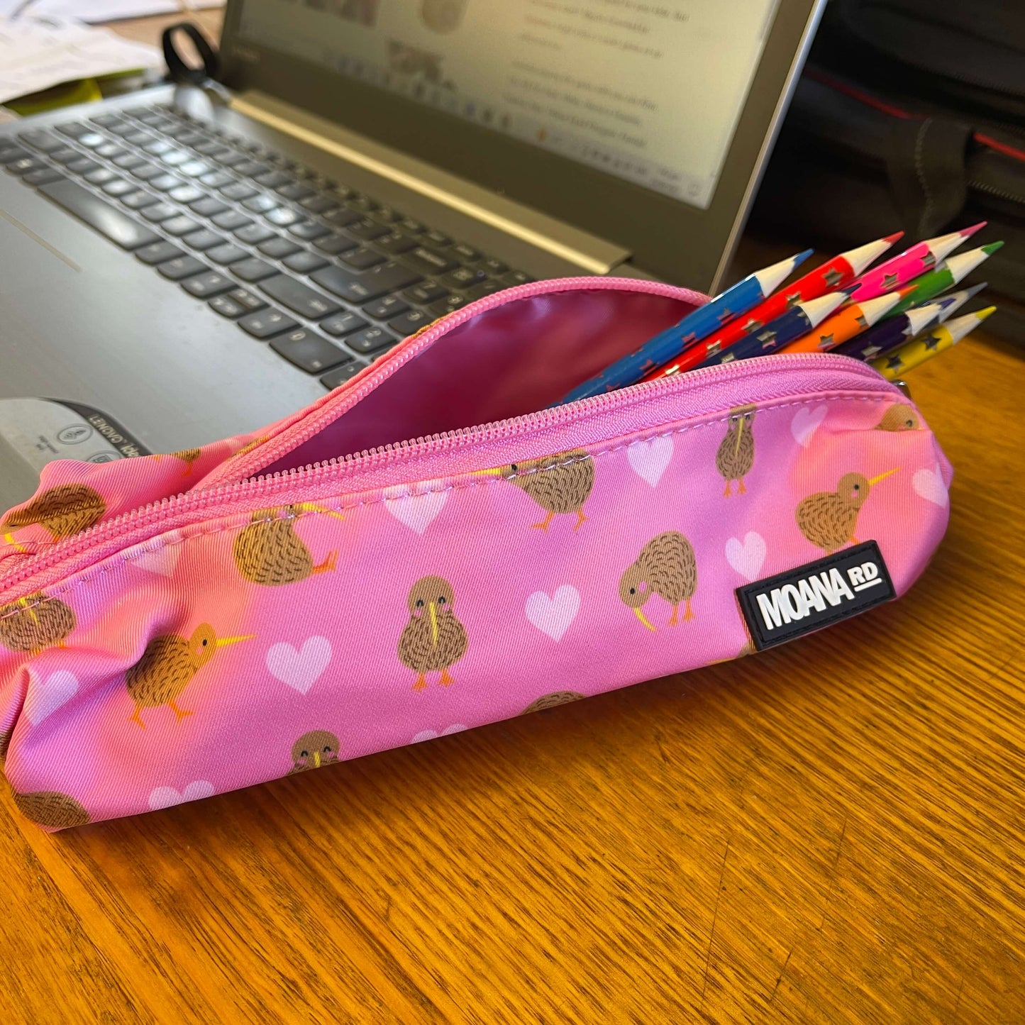 Pink pencil case with hearts and kiwi birds.
