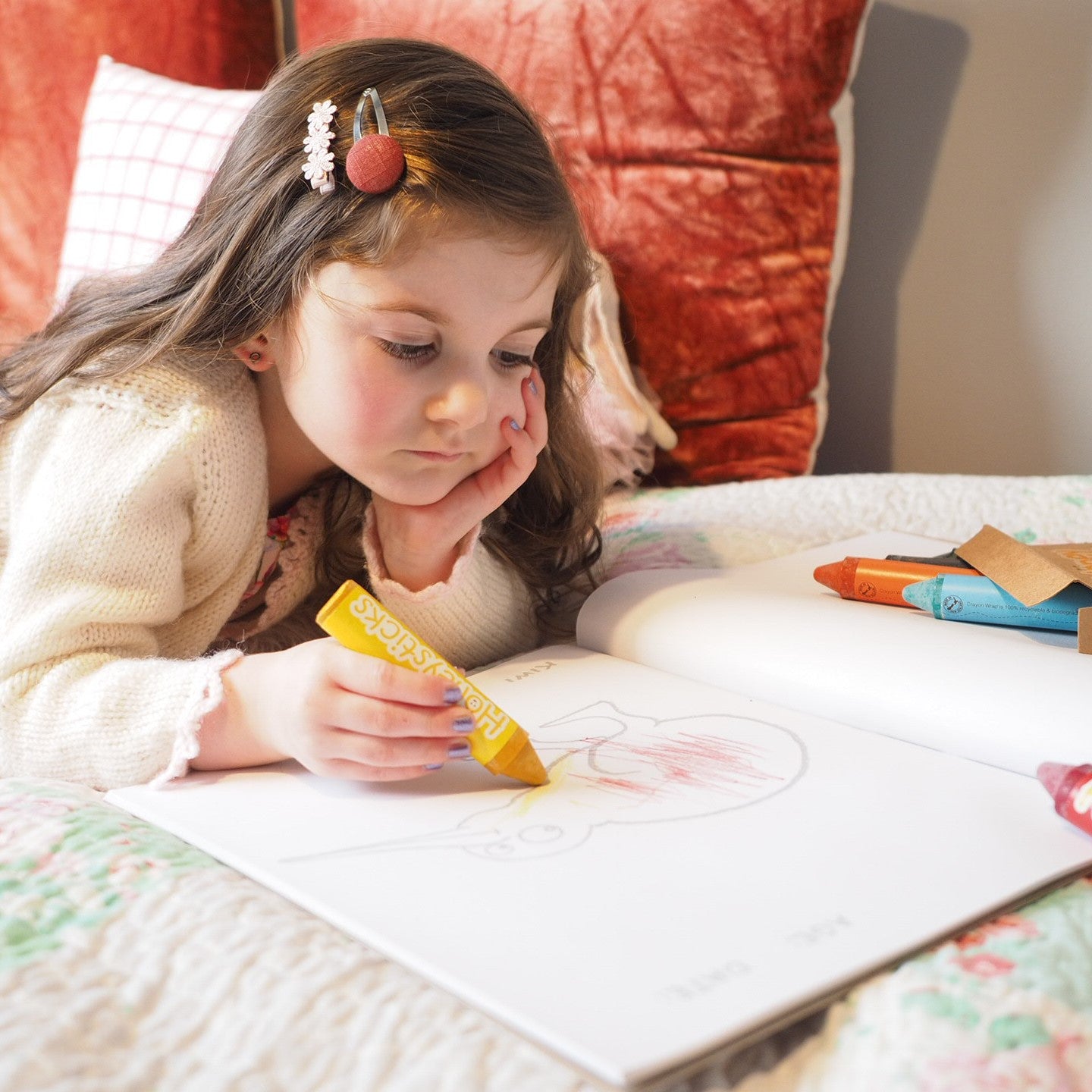 Child with Honeysticks colouring book and crayons.