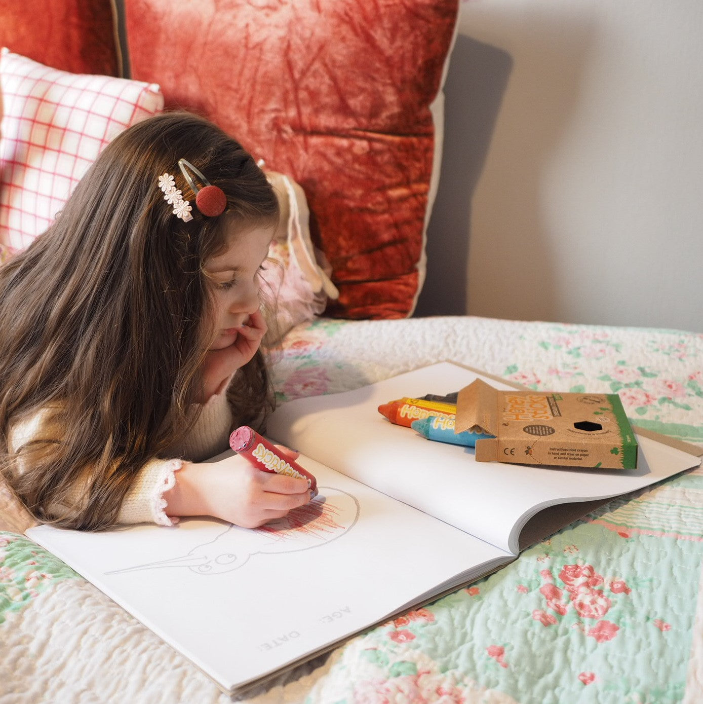 Child with Honeysticks colouring book and crayons.