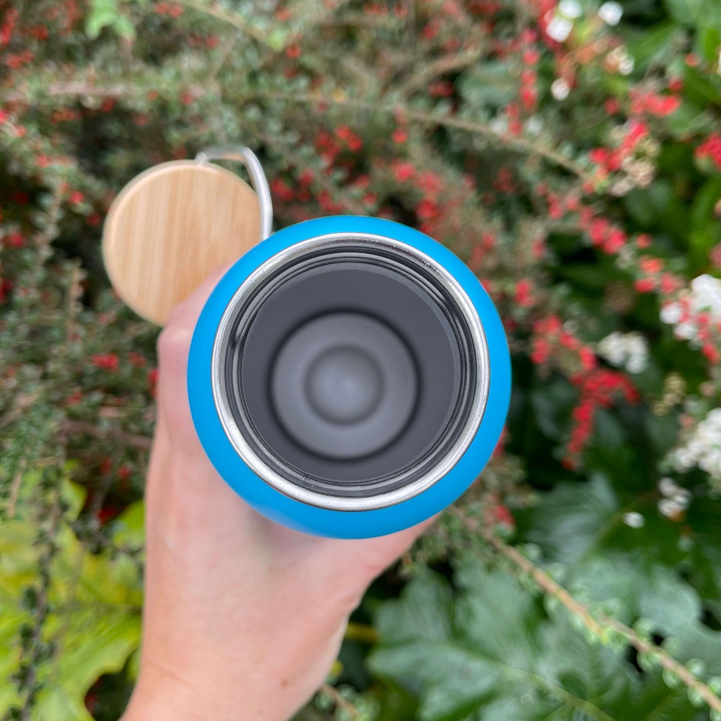 Birds eye view of open stainless steel drink bottle.
