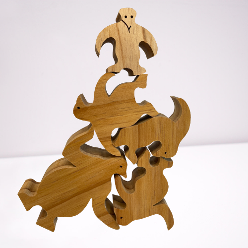Natural wooden balancing penguins.