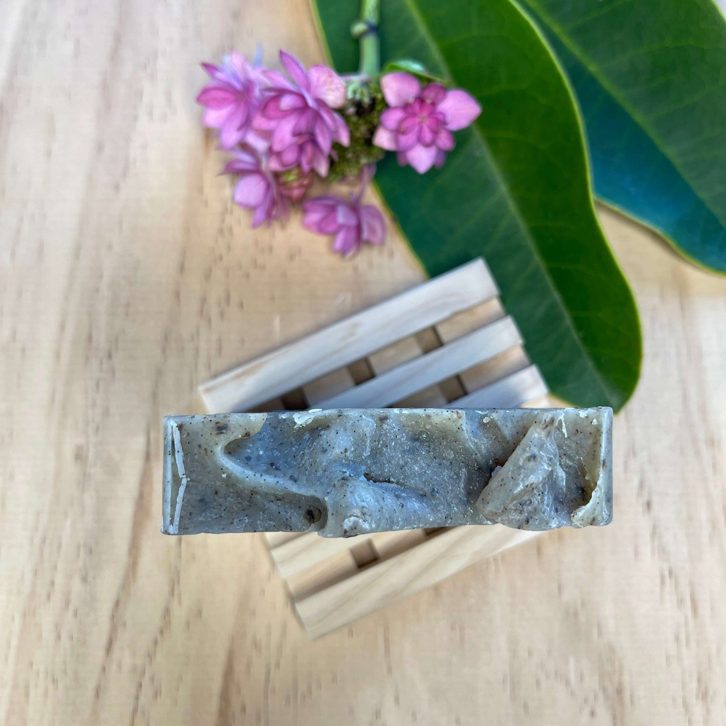 Vanilla body soap on a wooden soap dish.