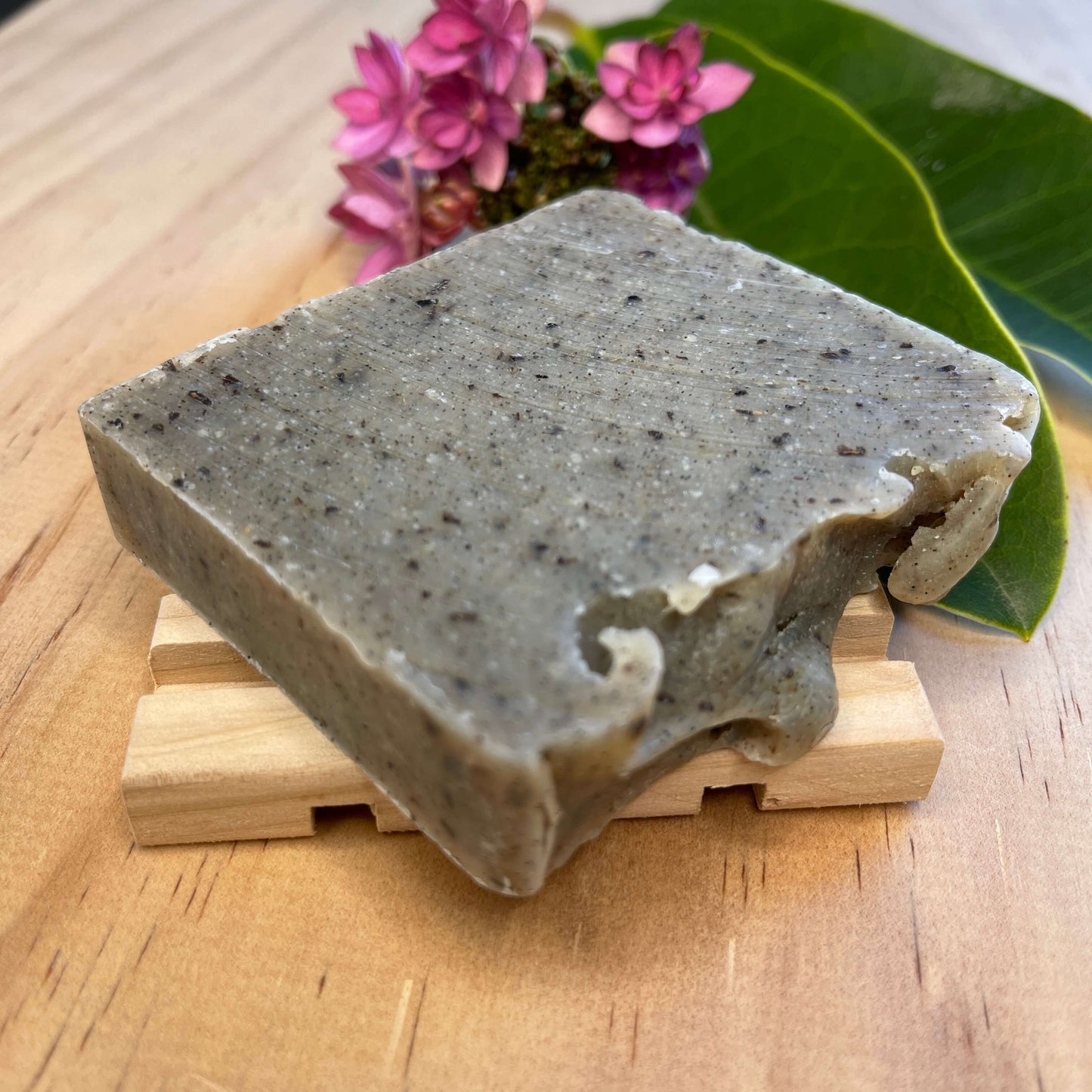 Vanilla body soap on a wooden soap dish.