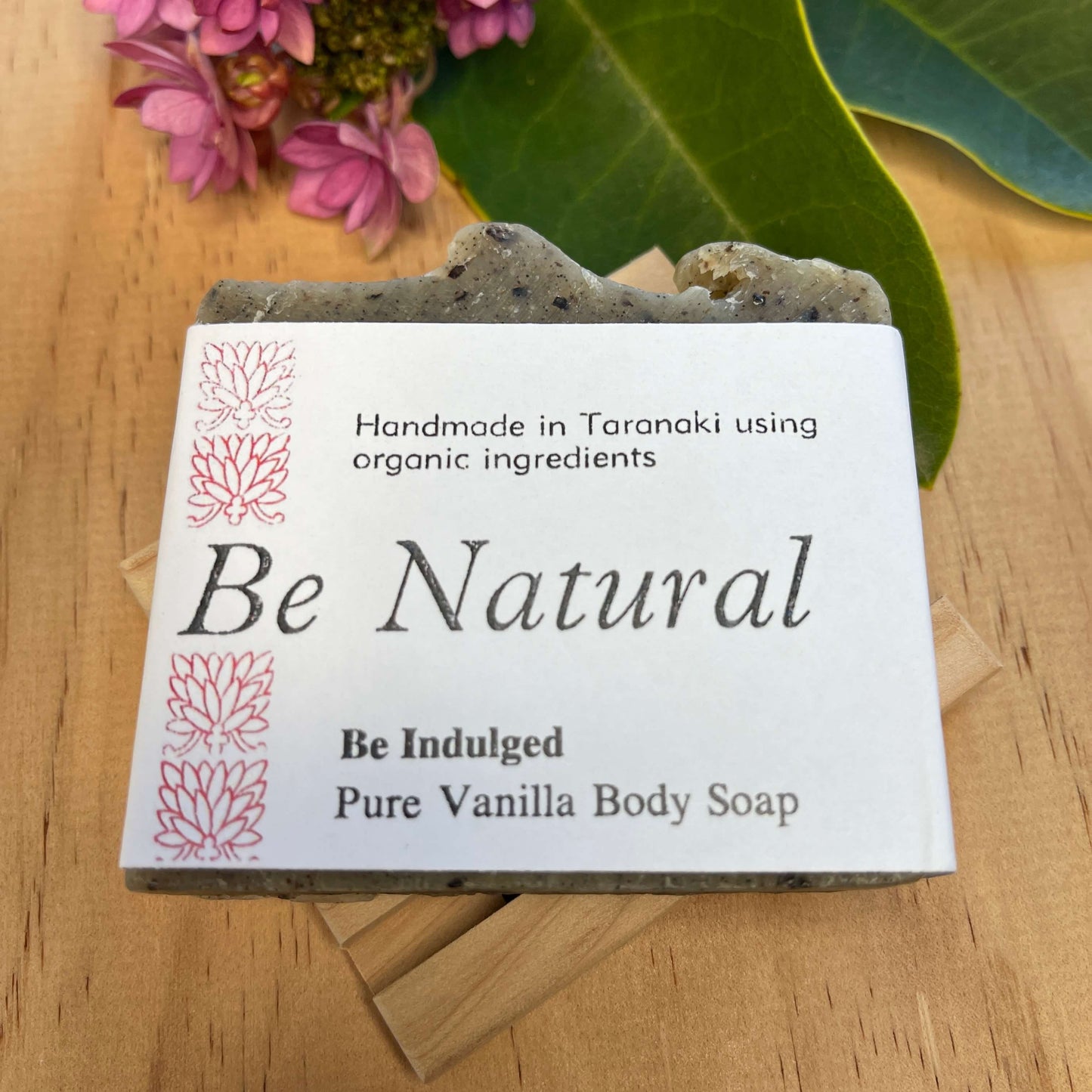 Vanilla body soap on a wooden soap dish.