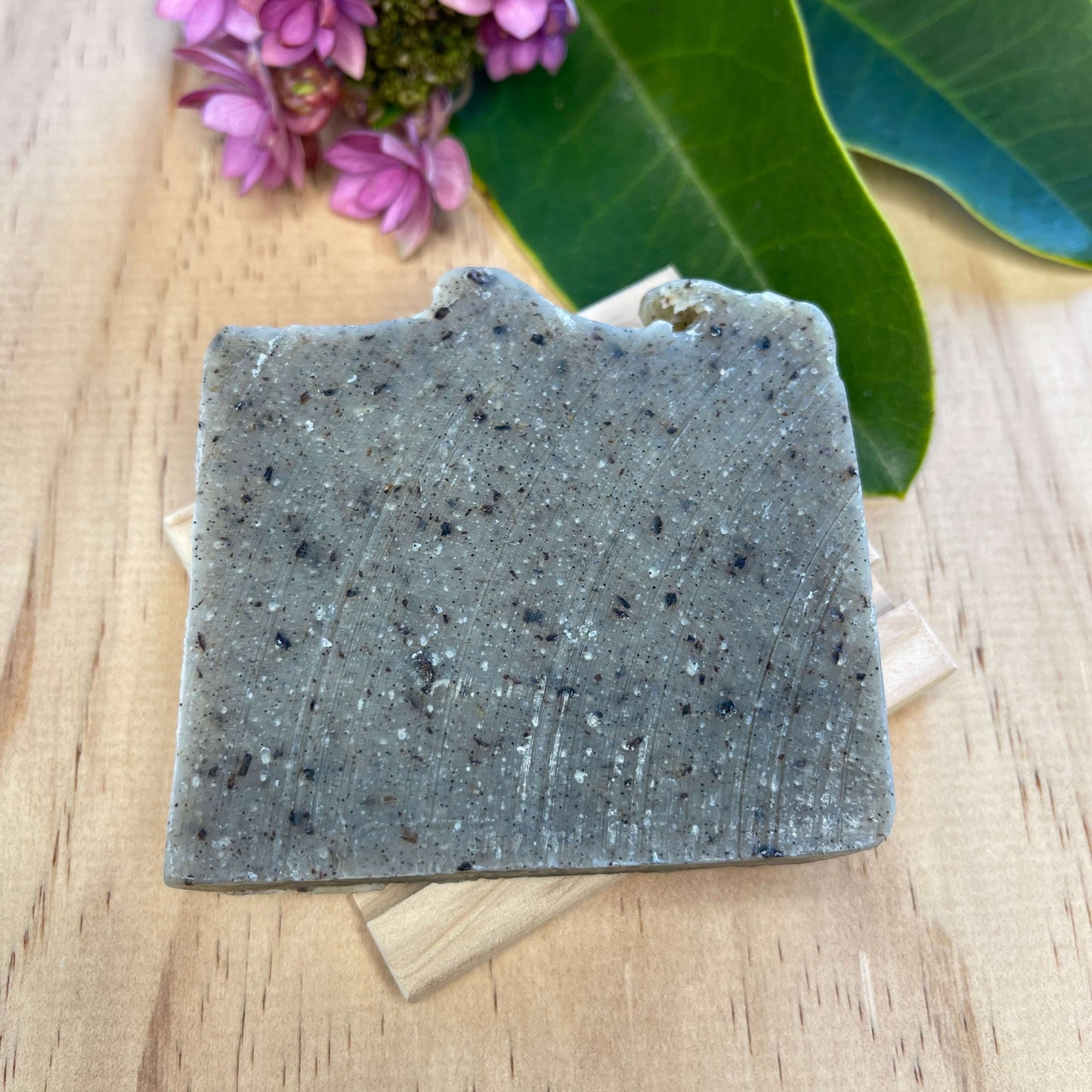 Vanilla body soap on a wooden soap dish.