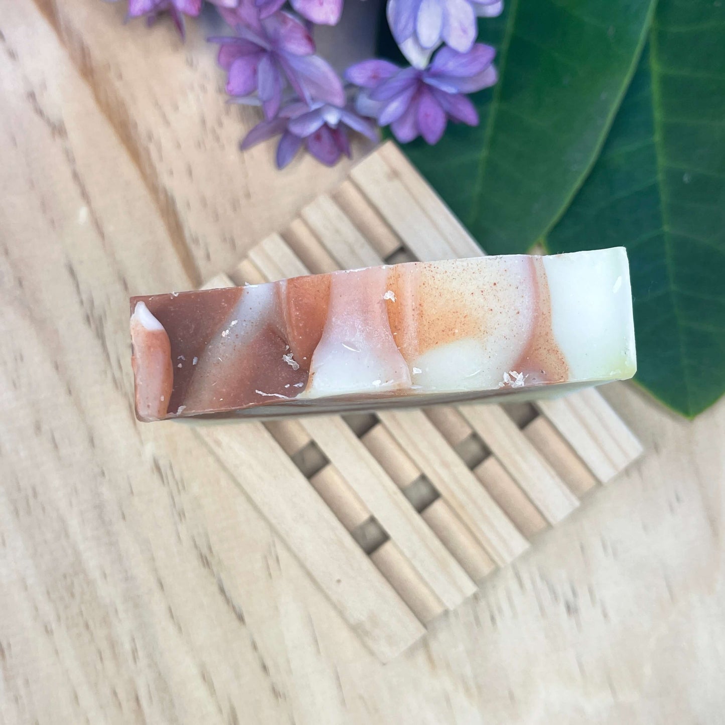 Natural soap bar on a wooden soap rack.