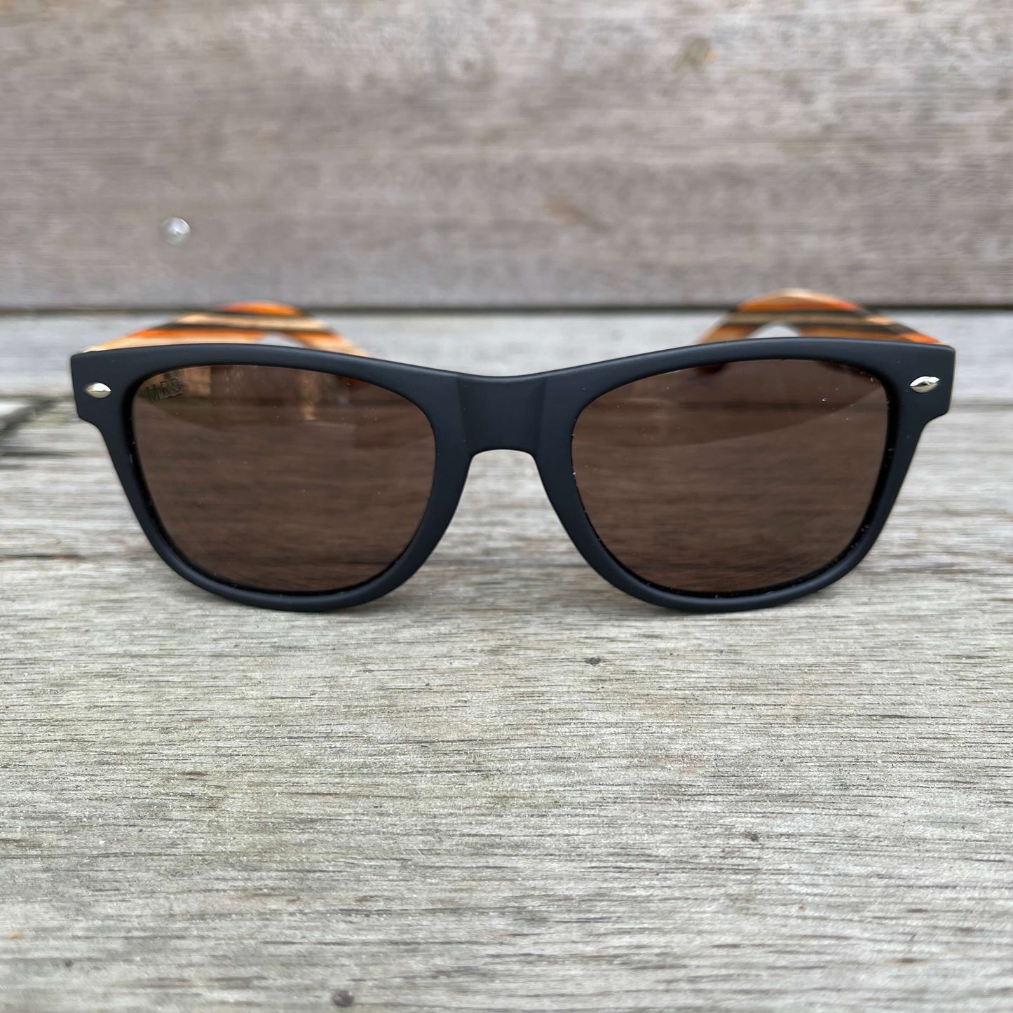Black frame sunglasses with wooden striped arms.