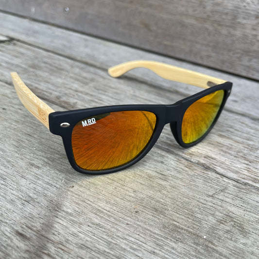 Sunglasses with wooden arms, black frames and reflective lenses.