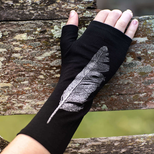 Fingerless merino gloves in black with silver feather print.