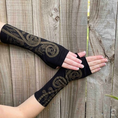 Fingerless merino gloves in black with gold fern print.