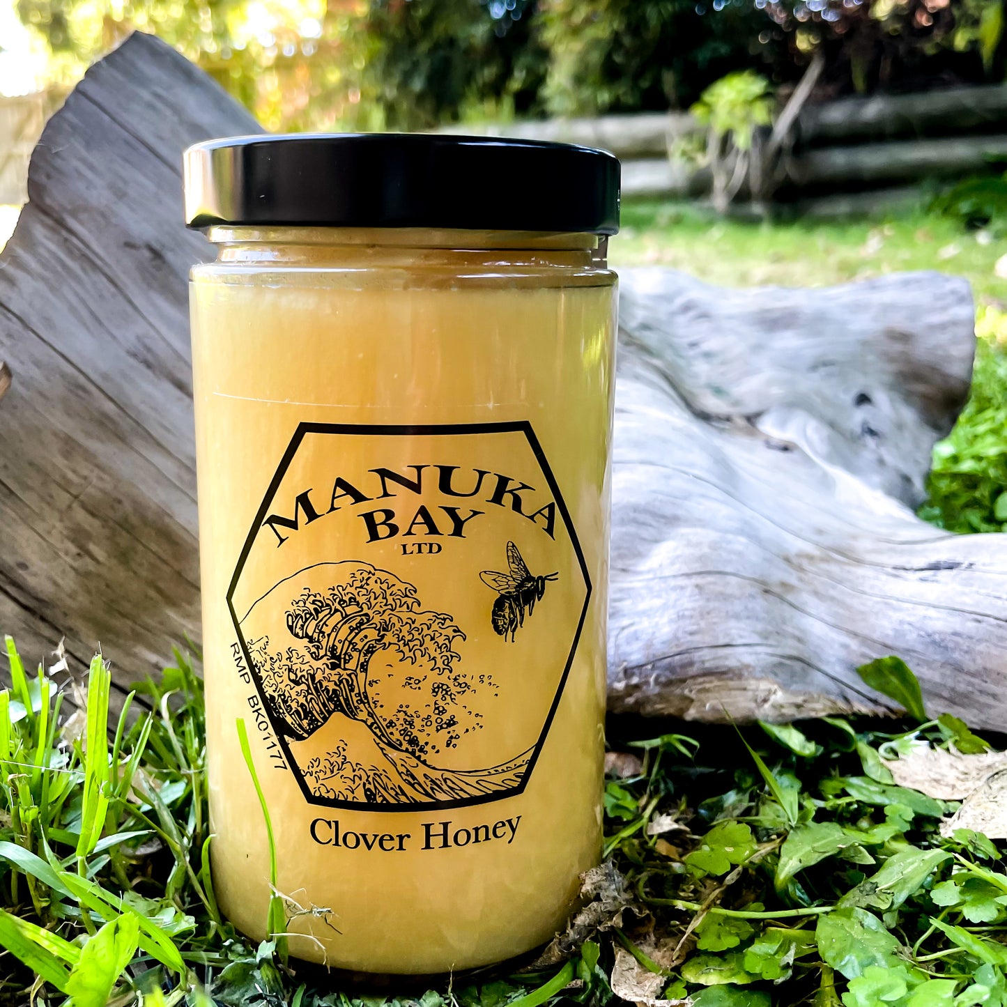Glass jar with black lid filled with Manuka Bay Clover Honey.
