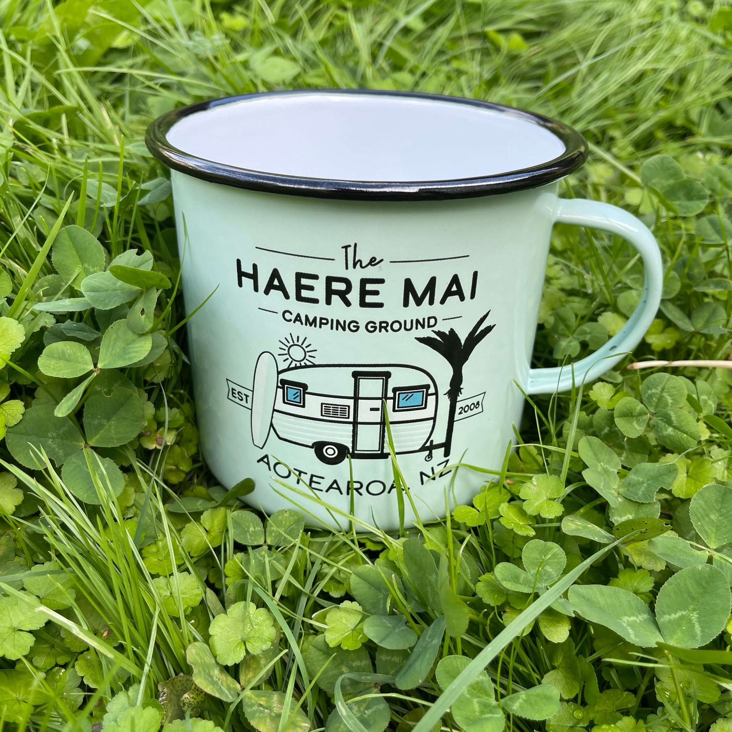 Large enamel mug with retro New Zealand camping scene.