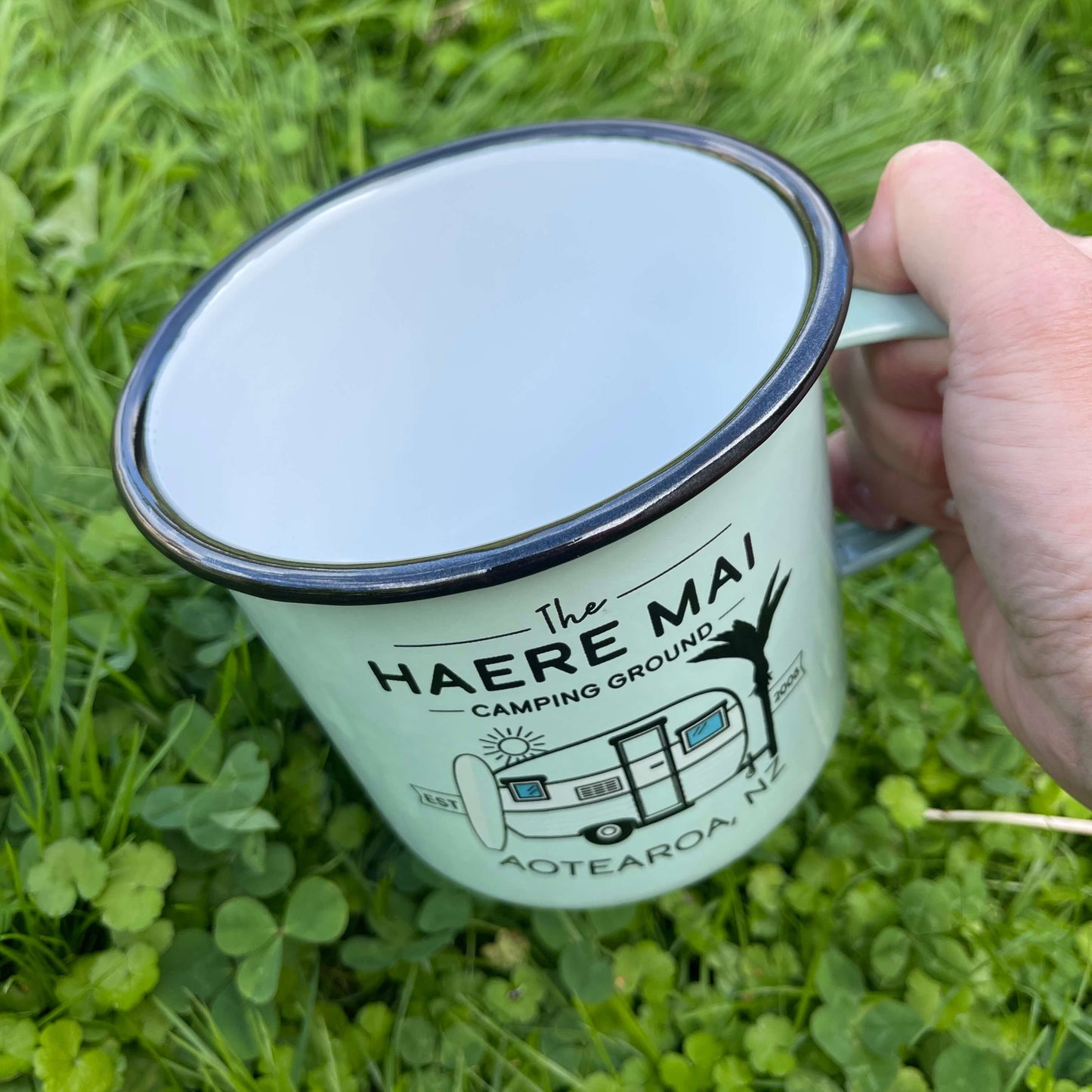 Large enamel mug with retro New Zealand camping scene.