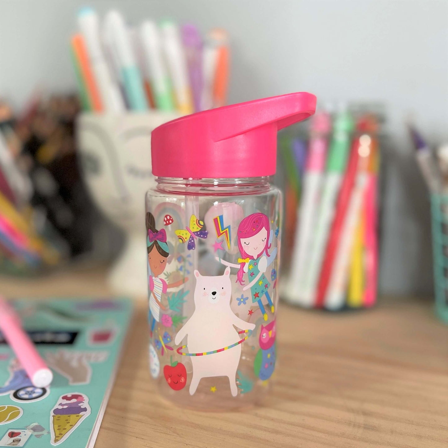 Kids drink bottle with fairies printed on it. Features bright pink lid with clear sipping tube.