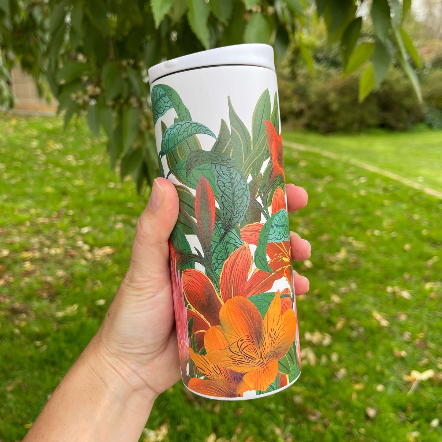 Stainless steel cup with Kaka bird and floral artwork by designer Flox.