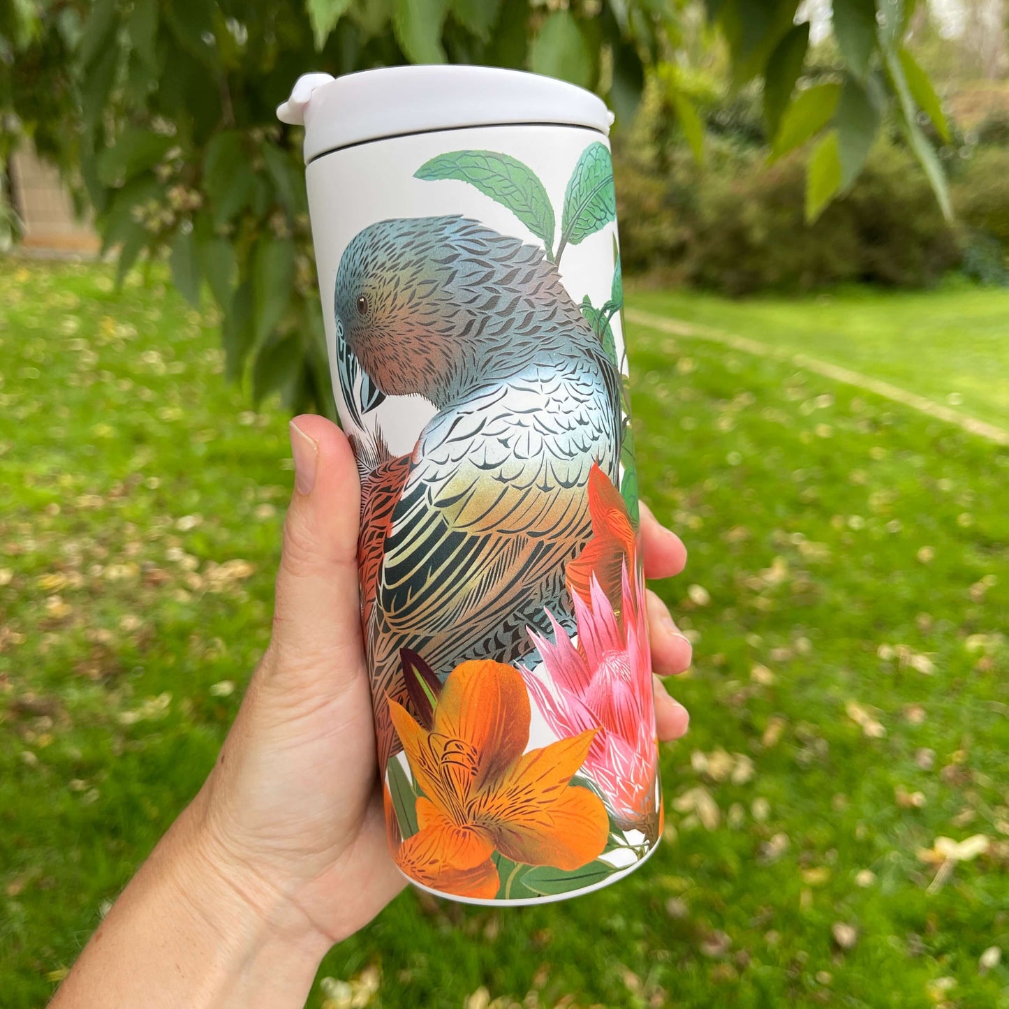 Stainless steel cup with Kaka bird and floral artwork by designer Flox.