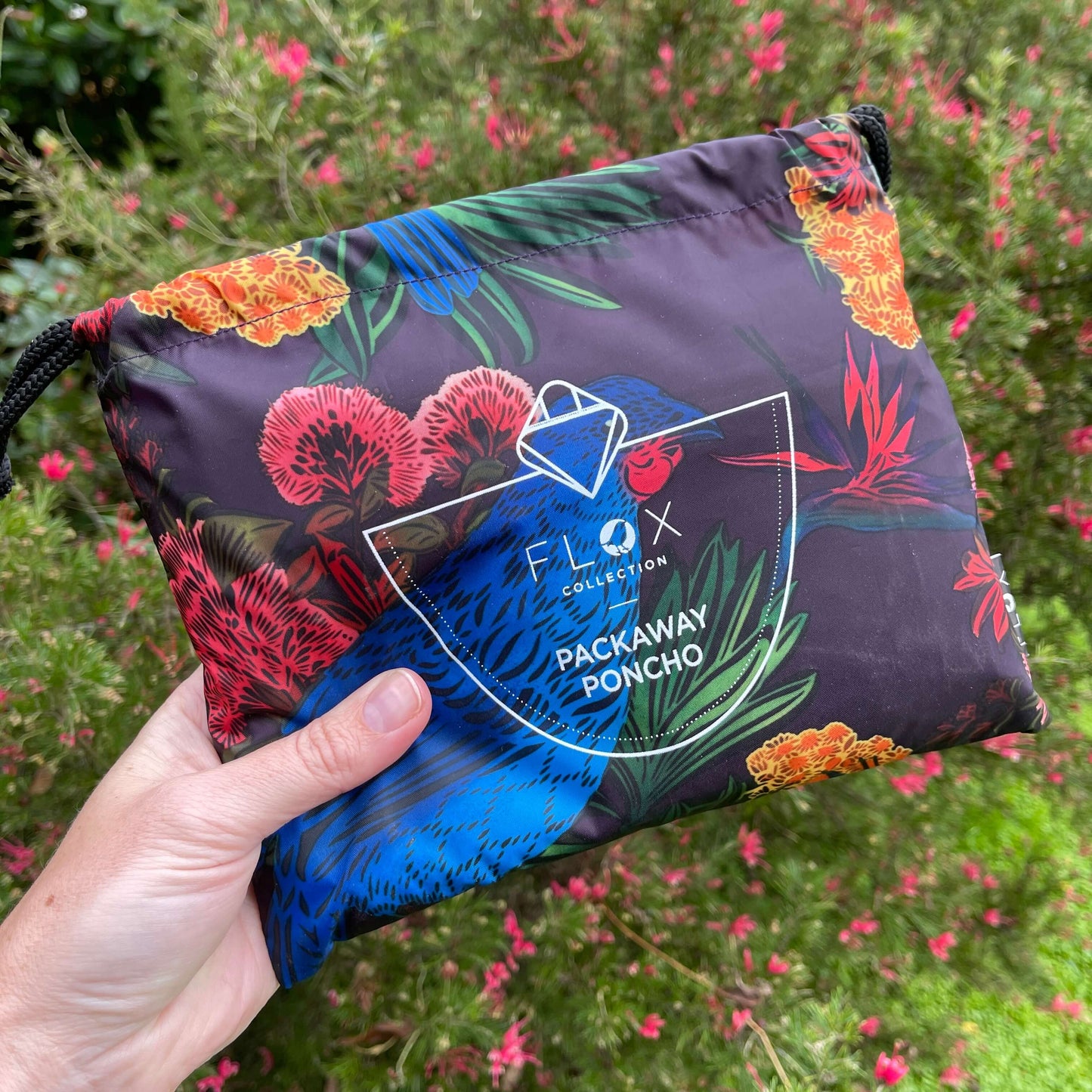 Hand holding a pouch for a rain poncho.