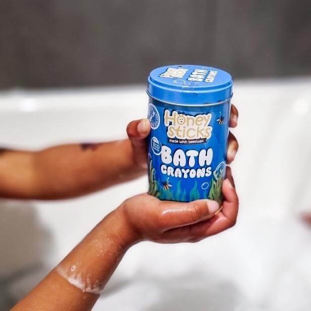 Bath crayons by Honey Sticks in a blue storage tin.