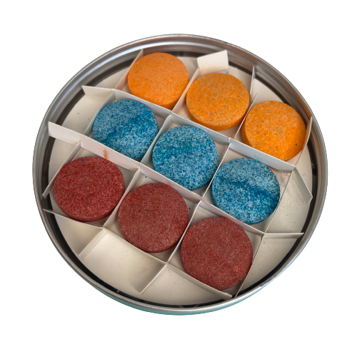 Honey Sticks bath colour drops in a tin.