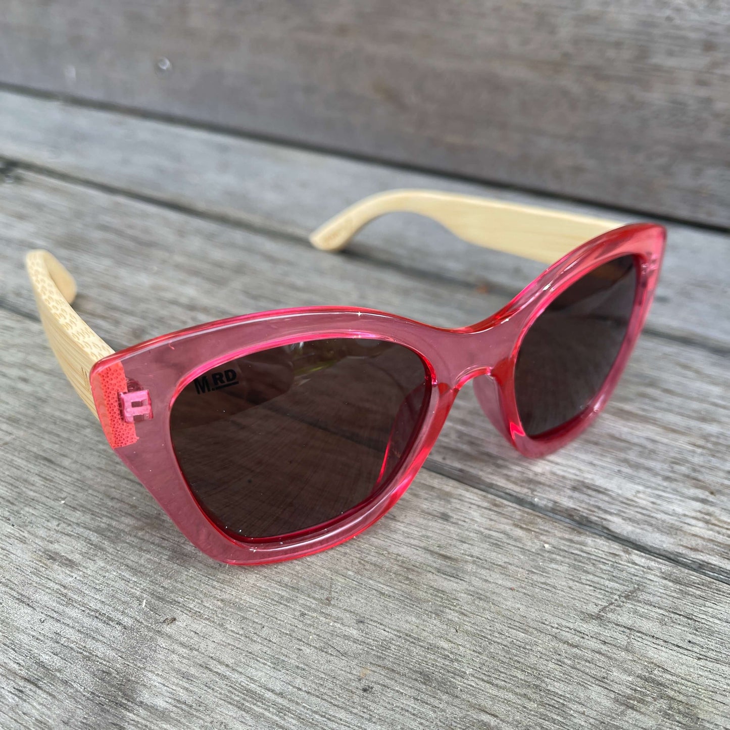 Womens sunglasses with pink frame and bamboo arms.