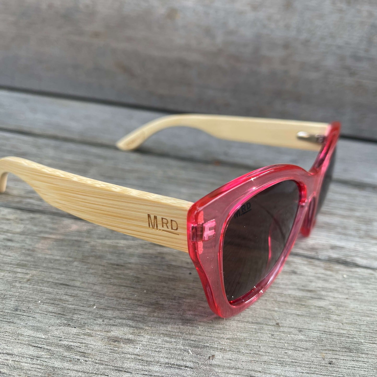 Womens sunglasses with pink frame and bamboo arms.