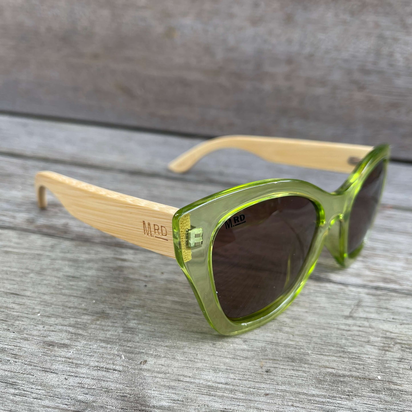 Womens sunglasses with light green frame and bamboo arms.