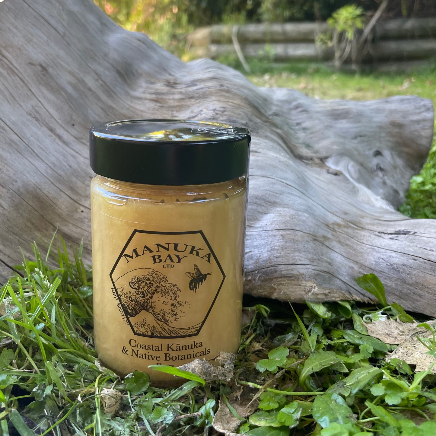 Glass jar with black lid filled with Manuka Bay Kanuka Honey.