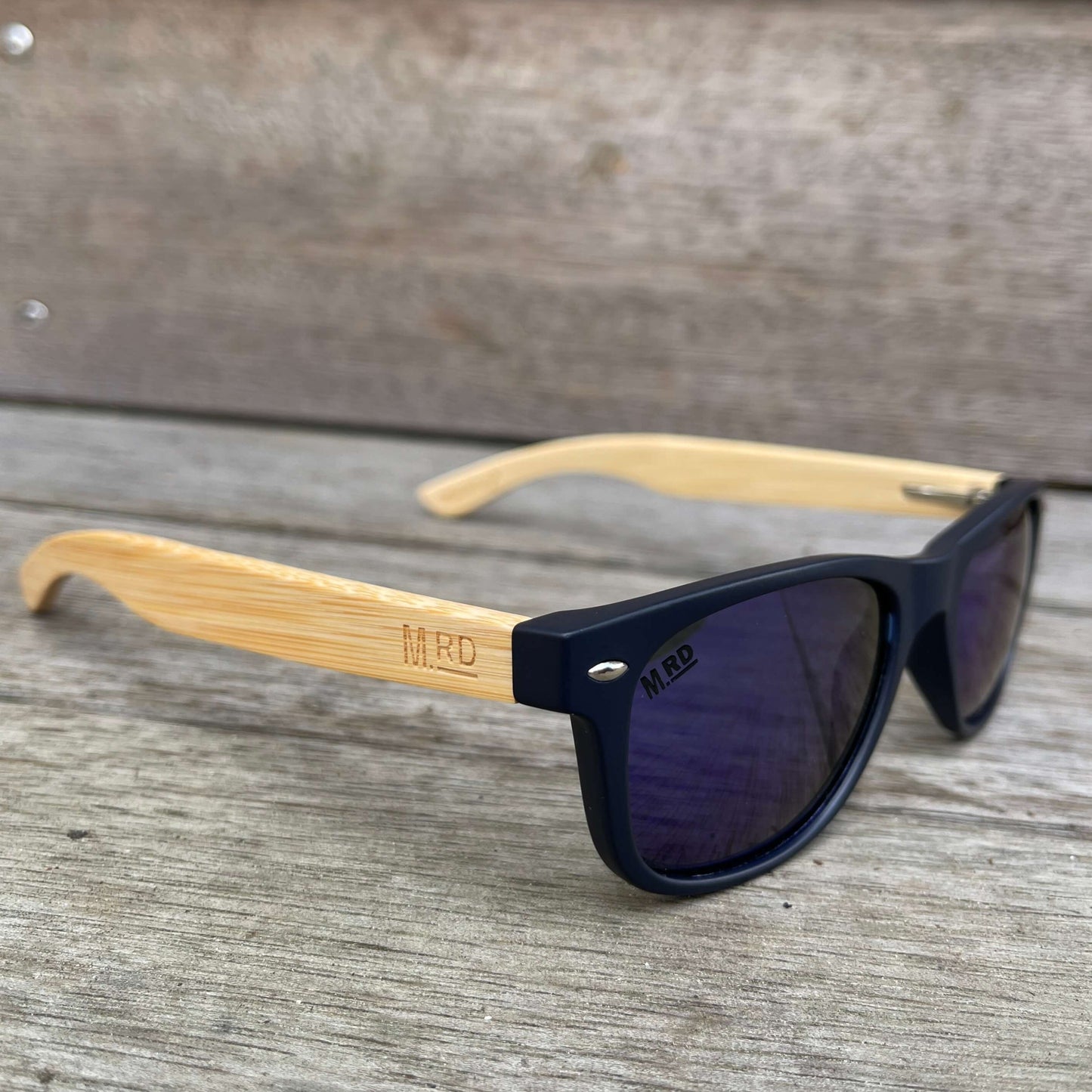 Kids sunglasses with Navy blue frames, blue lenses and wooden arms.
