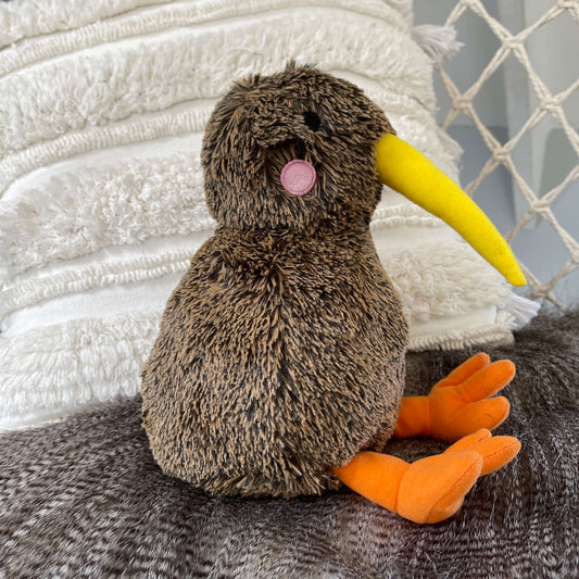 Soft toy Kiwi bird in brown with yellow beak and orange feet.