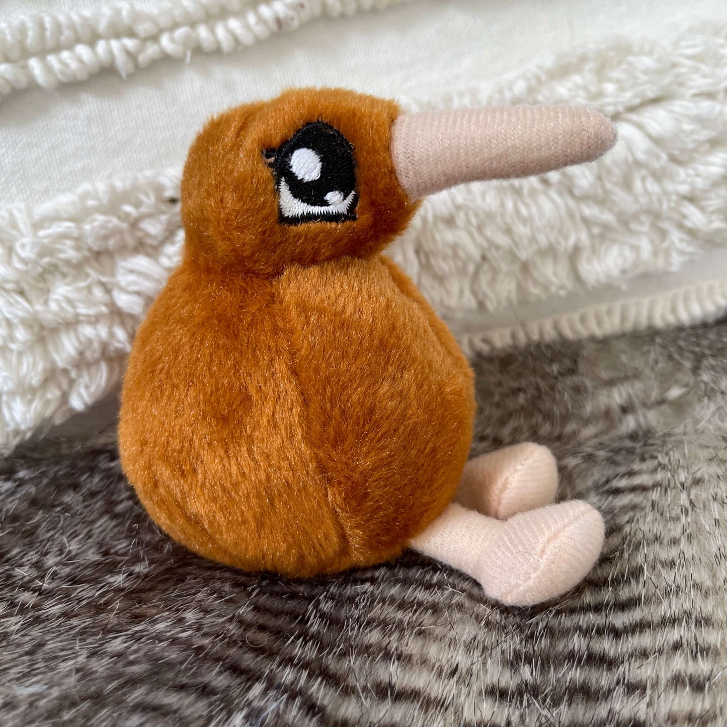 Mini kiwi plush toy in light brown with beige beak and feet.