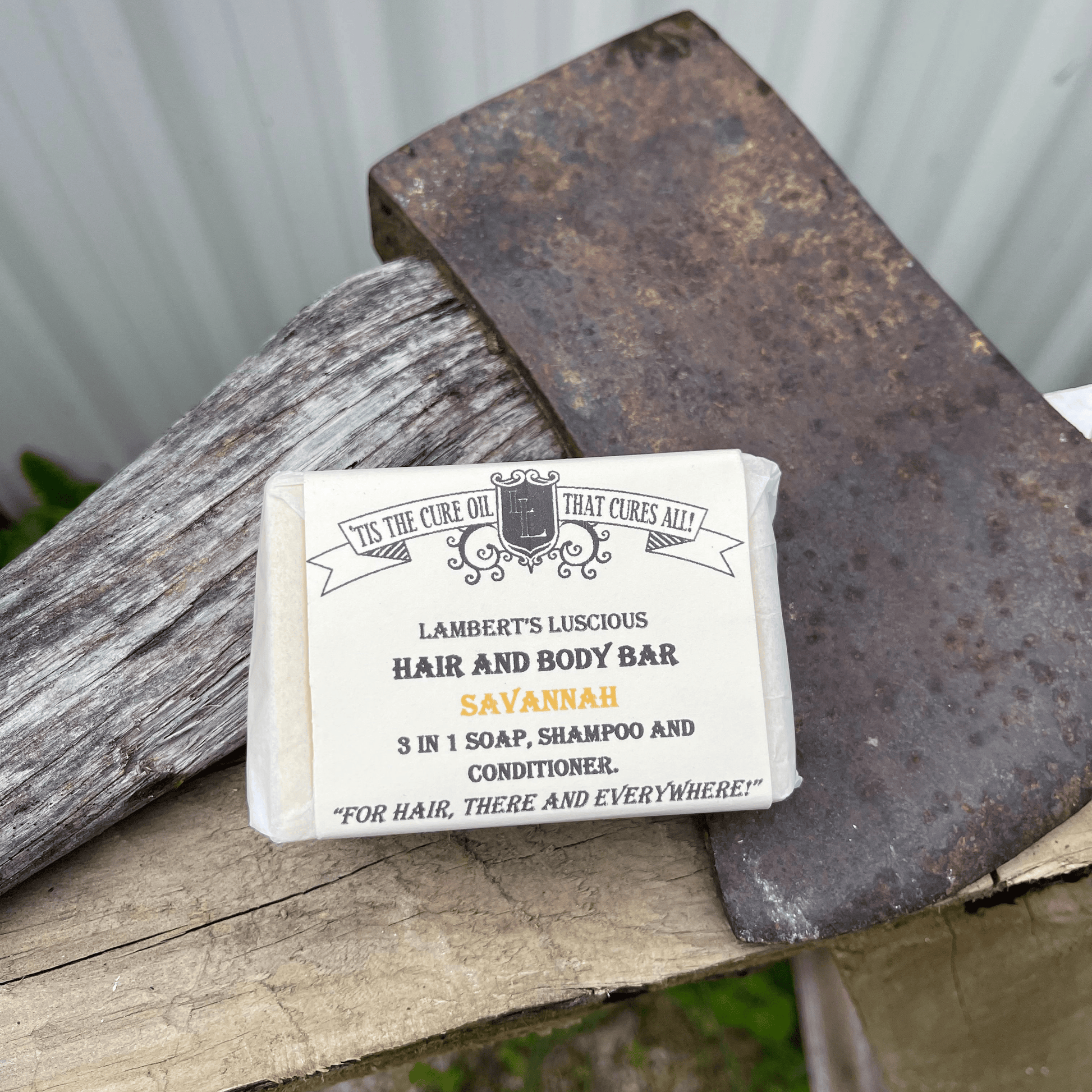 Lamberts Luscious Hair and body bar resting against an axe head.