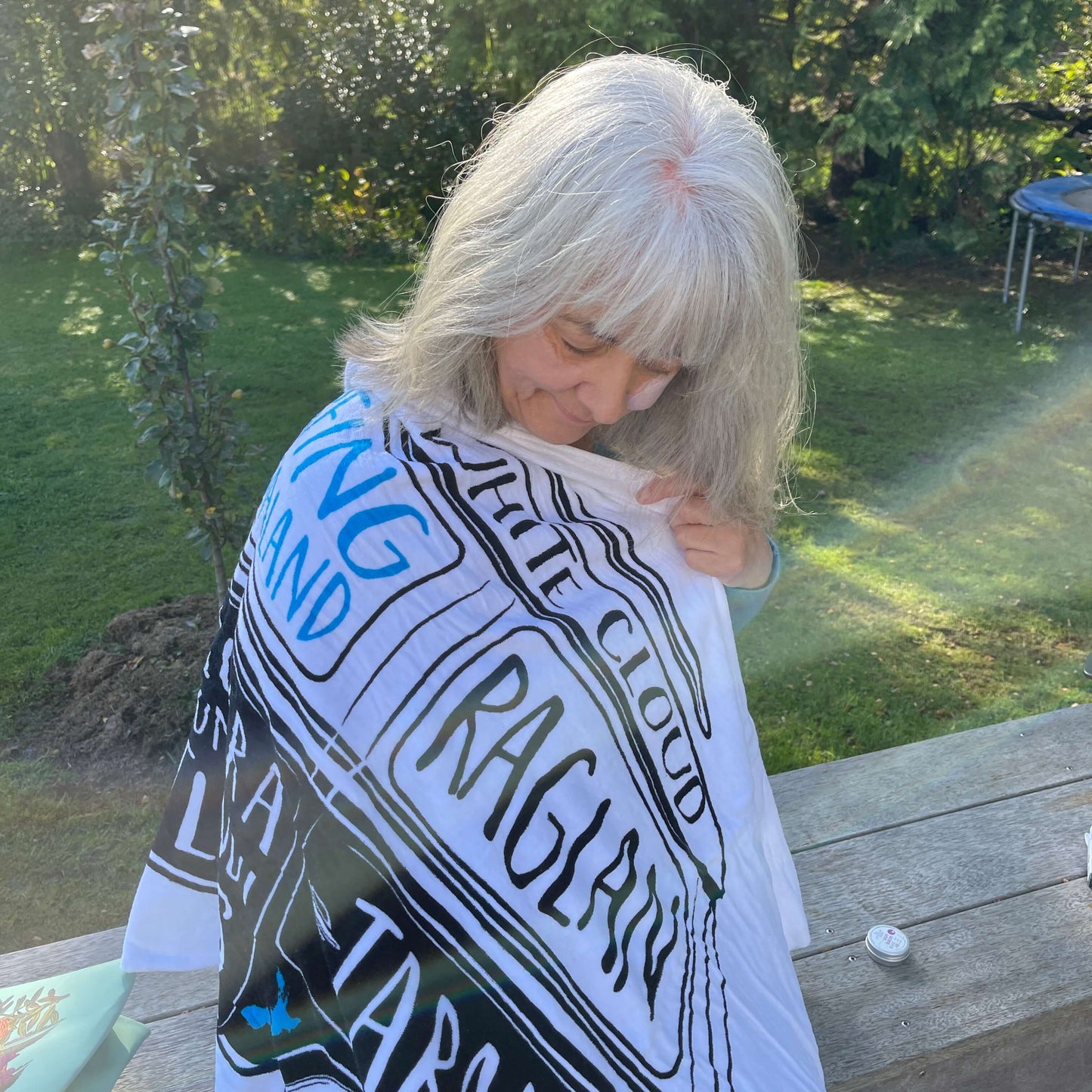 Woman with a beach towel draped around her.