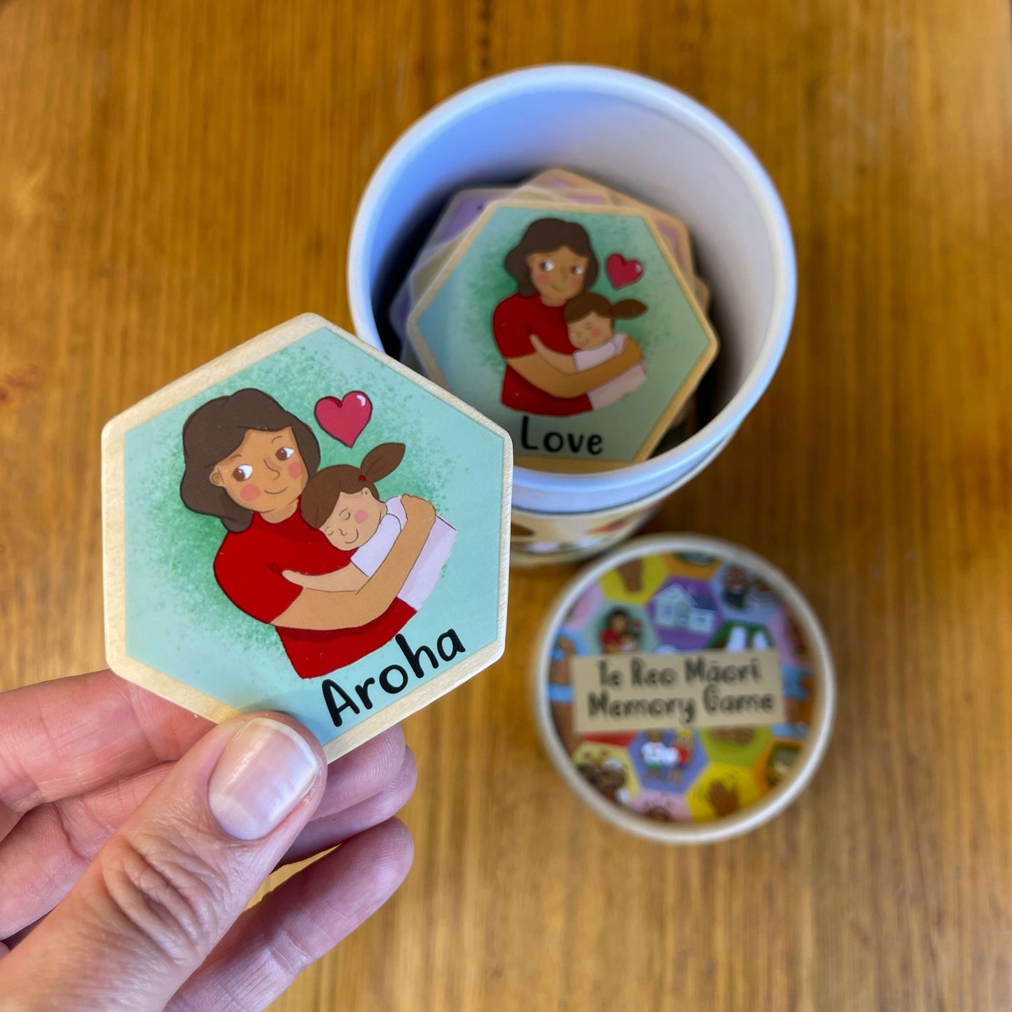 Wooden hexagon blocks featuring Aroha or Love as part of a Te Reo Maori Memory Game.