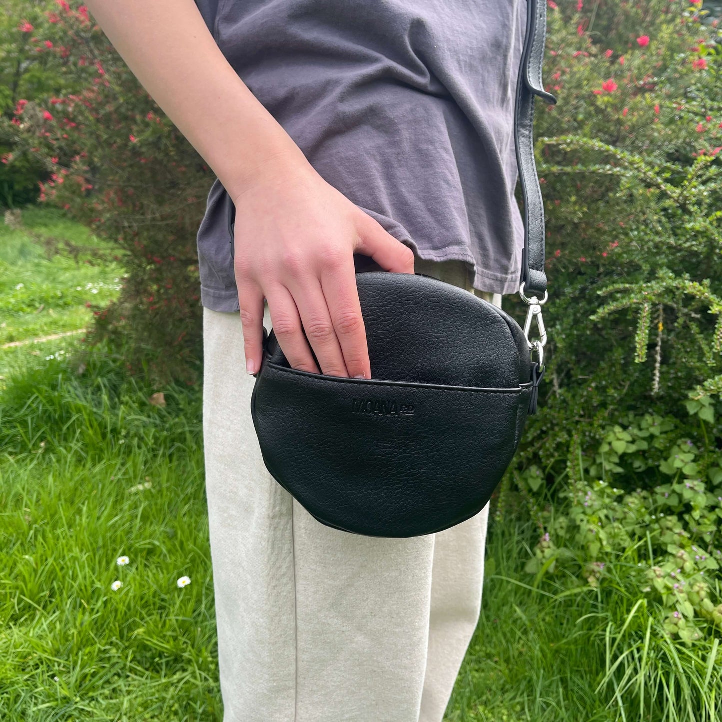 Black shoulder bag with front pocket.