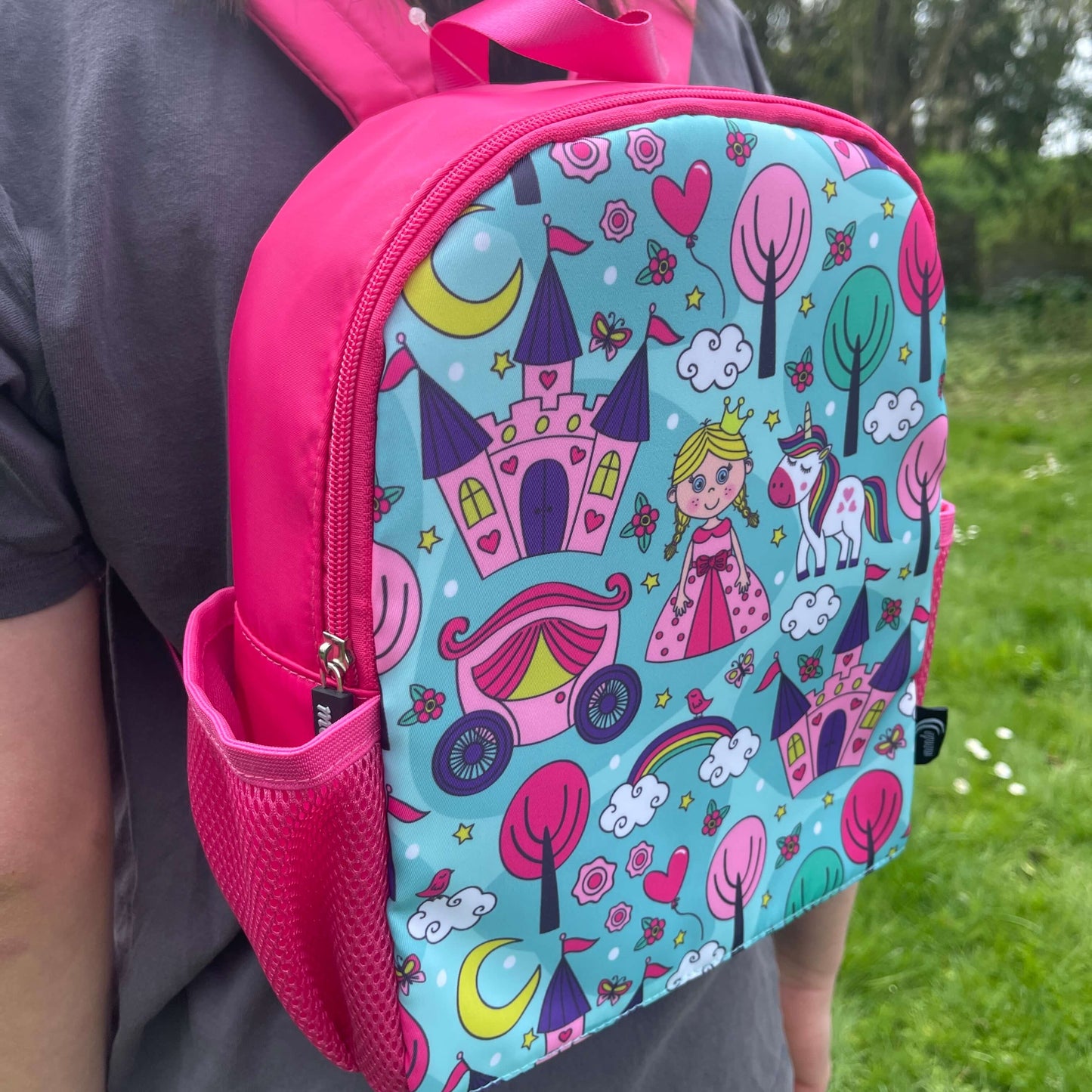 Bright pink childs backpack with blue front and princess pictures.