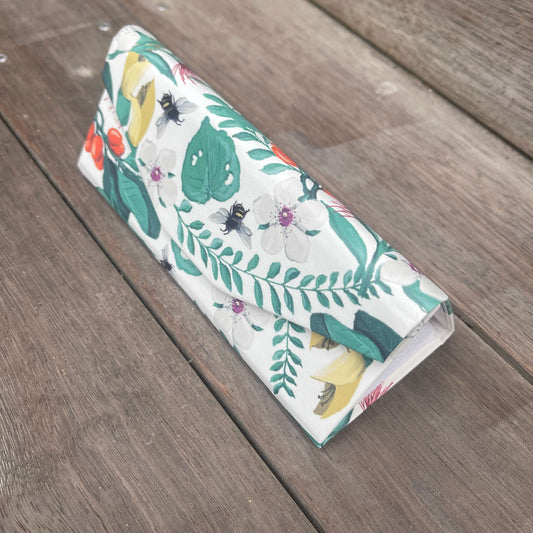 Floral sunglasses case that folds flat when not in use.