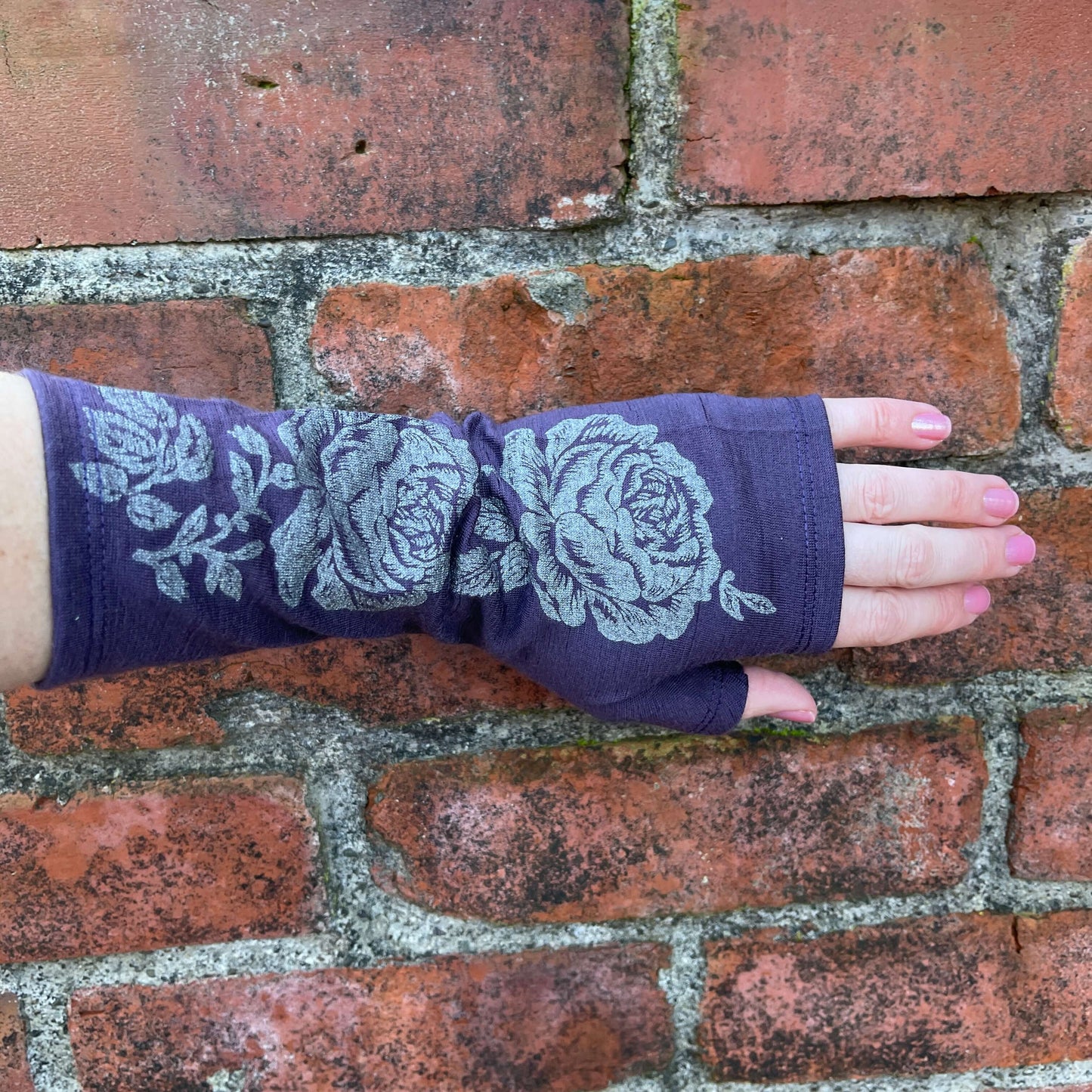 Fingerless merino gloves in purple with silver rose print.