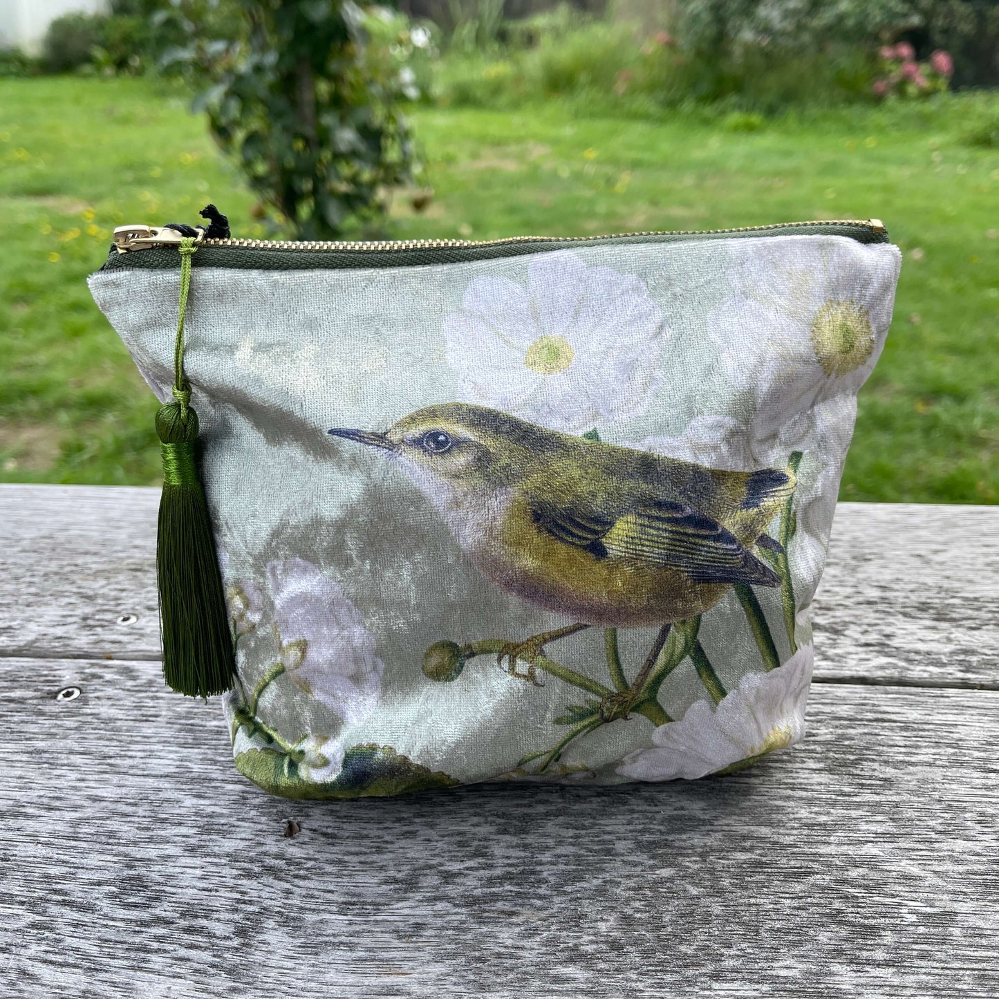 Velvet cosmetic bag featuring a Rifleman bird and Mt Cook Lily.
