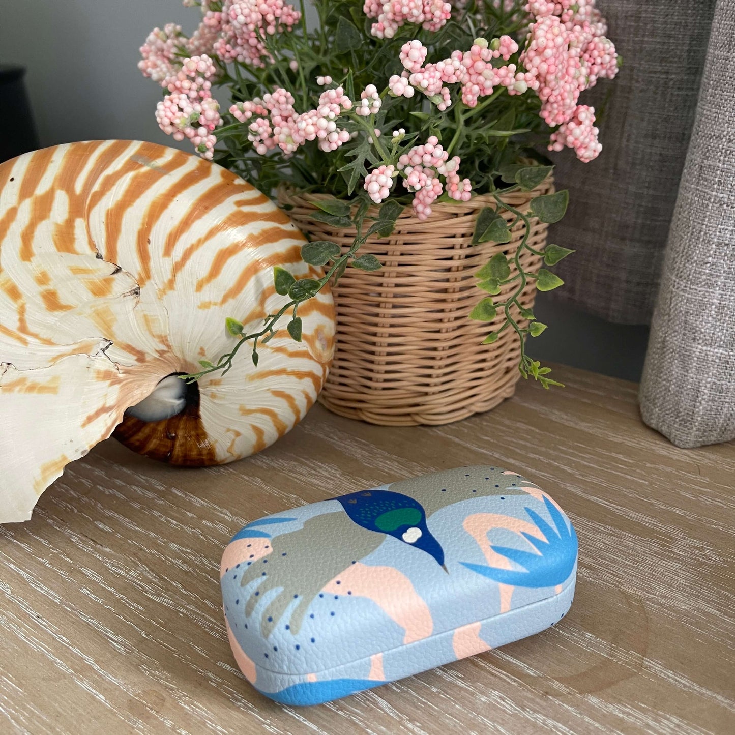 Small trinket case with Tui Bird print in pinks and blues.