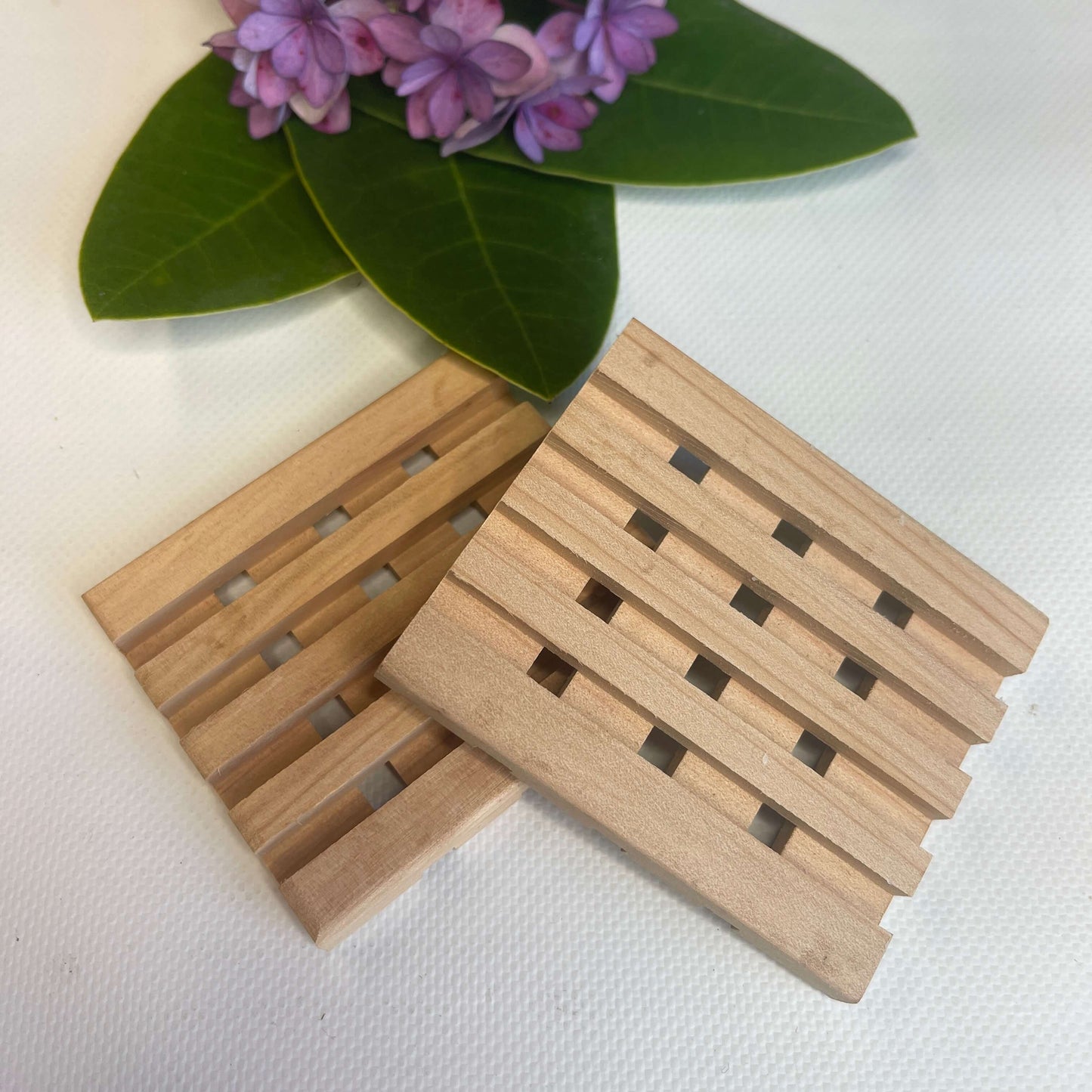 Two wooden soap dishes