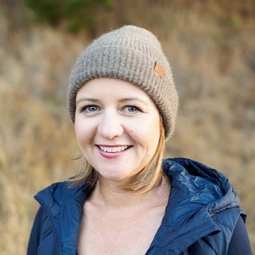 Portrait of a woman wearing a Wyld knit woolen beanie.