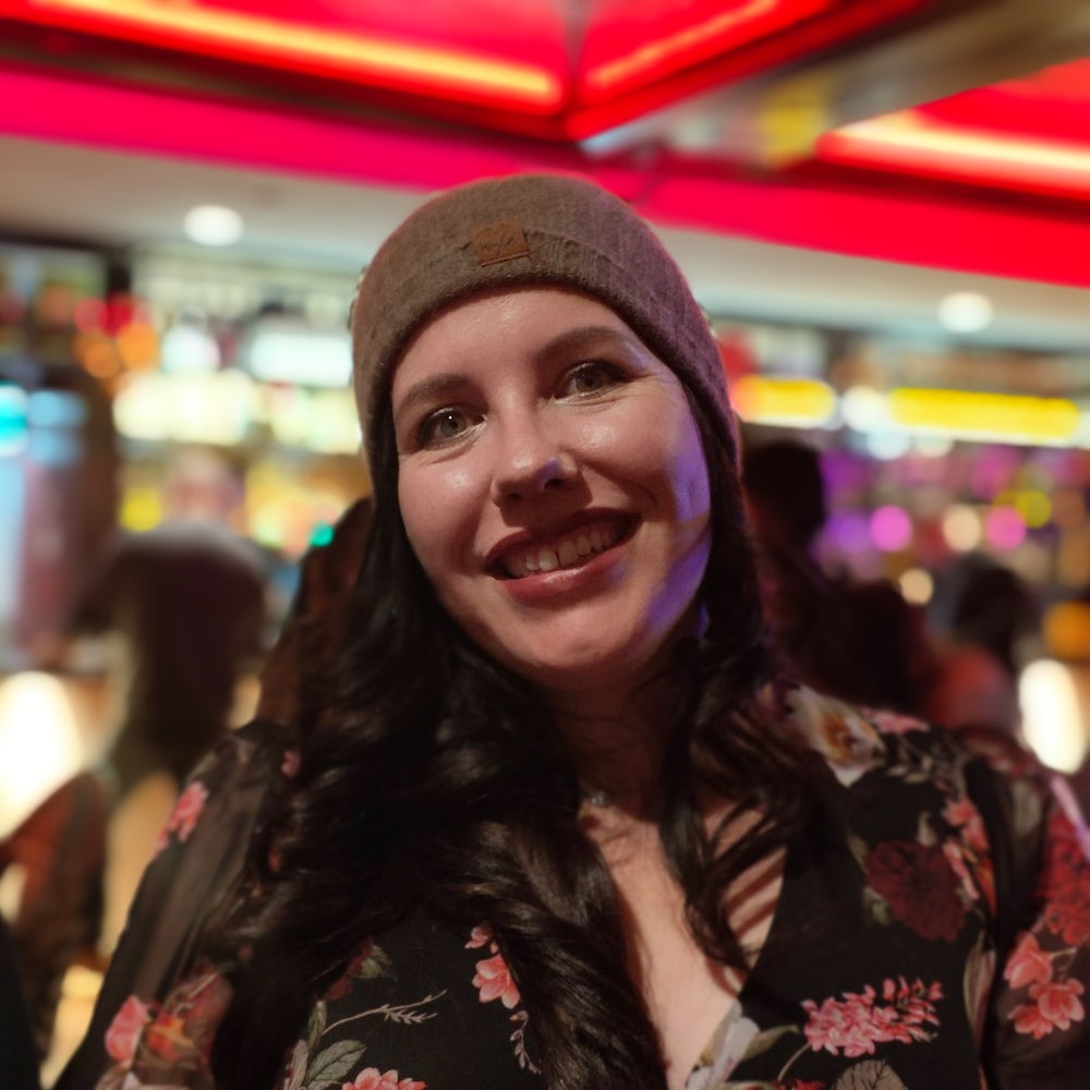 Woman wearing a Cable knit beanie in natural brown wool from Wyld